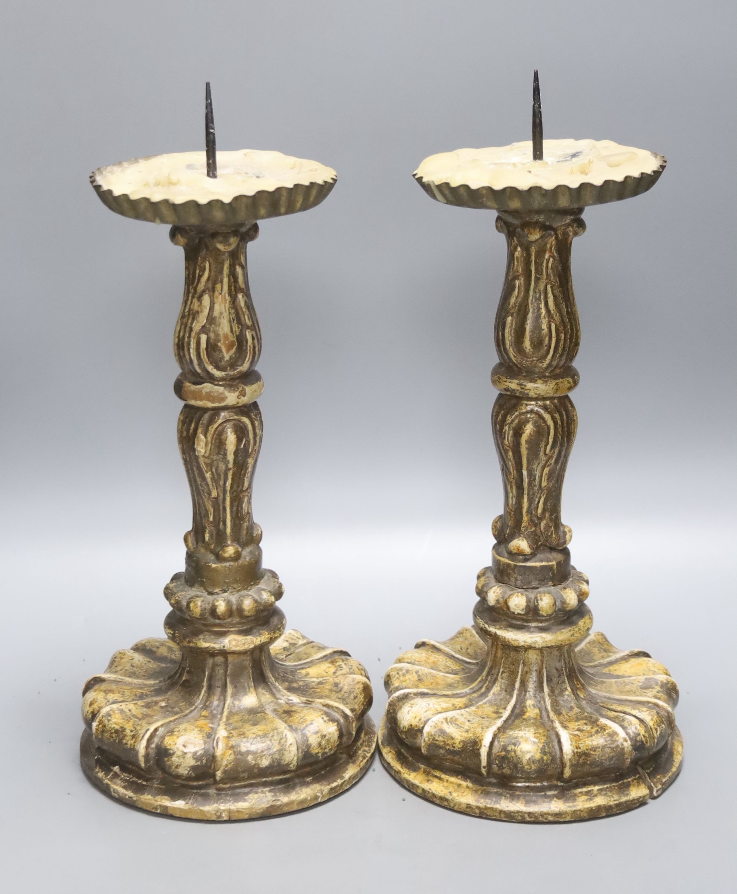 A pair of giltwood and gesso pricier candlesticks in the 17th century Italian style, height 29cm